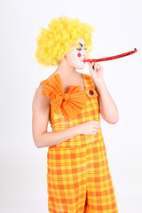 Funny clown in costume with whistle