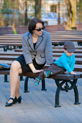 Mother and son sitting outdoors