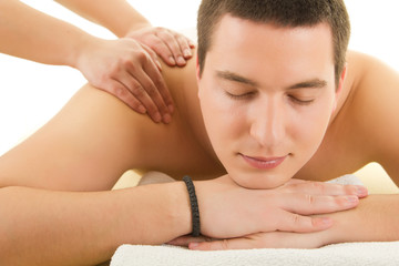 Close-up of an attractive man having a back massage