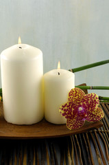 Fototapeta na wymiar Aromatic candles and romantic orchids