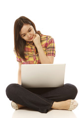 Naklejka premium Young Woman Looking at Laptop