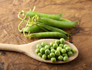 Wooden spoon with fresh peas