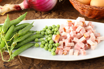 Bacon and fresh peas on dish