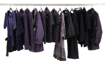 A row of designer fashion clothing hanging on hangers