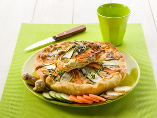 vegetables cake over dish on green background