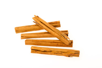Five cinnamon sticks isolated on white background