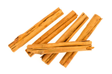 Five cinnamon sticks isolated on white background