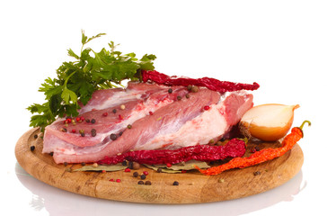 Raw meat and vegetables on a wooden board isolated on whitе