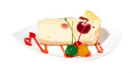 Closeup of a slice of cherry cheesecake on a white background