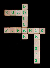 Green letters on old wooden blocks (euro, dollar, finance, crisi