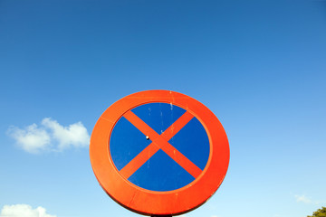 No parking and stopping sign under blue sky