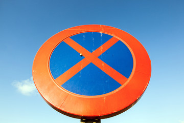 No parking and stopping sign under blue sky