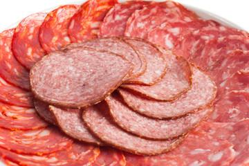 Chorizo, salchichon, salami sausages on a white plate