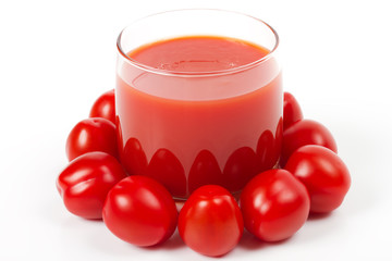 Glass of tomato juice and ripe tomatoes