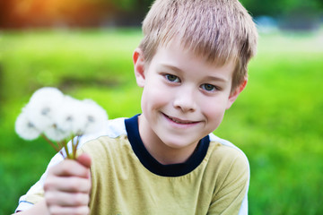 smiling boy with dandelions