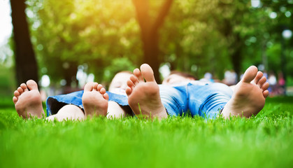 feet on grass. Family picnic in spring park