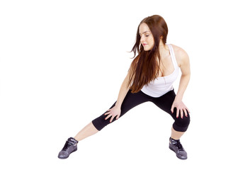 Young woman stretching muscles and tendons during exercise.