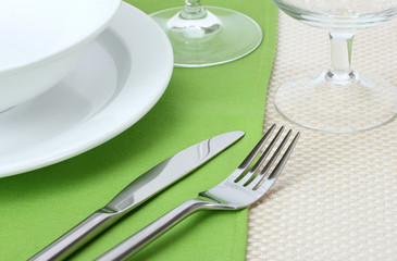 Table setting with fork, knife, plates, and napkin