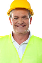 Smiling senior builder wearing hardhat