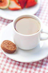 Obraz na płótnie Canvas cup of tea,cookie, fig and strawberries on a plate