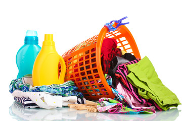 Clothes with detergent and in green plastic basket dropped