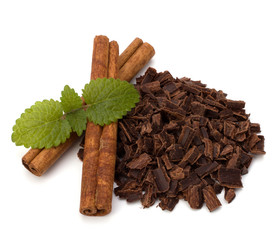 Crushed chocolate shavings pile and cinnamon sticks