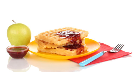 Tasty waffles with jam on plate isolated on white