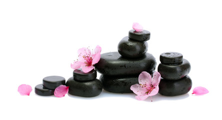 Obraz na płótnie Canvas Spa stones with drops and pink sakura flowers isolated on white.