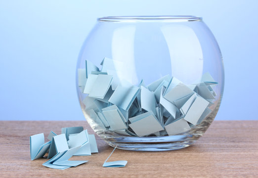 Pieces of paper for lottery in vase