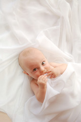 baby with white blanket