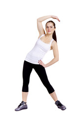 A slim young pretty woman stretching muscles and tendons