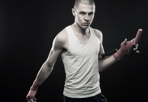 Young man posing with nunchaku