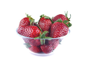 Glass bowl full of fresh strawberries isolated on white