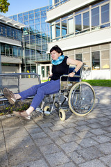 Woman tries to sit in a wheelchair
