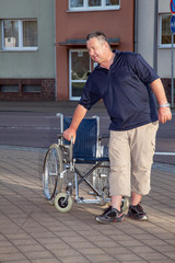 Man standing from the wheelchair to
