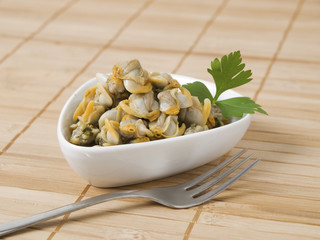 Bowl with cockles and fork