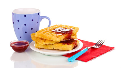 Tasty waffles with jam on plate isolated on white