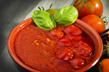 bowl with tomato sauce and basil