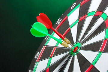dart board with darts on green background