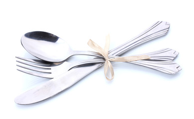 Silver fork, spoon and knife tied with ribbon isolated on white