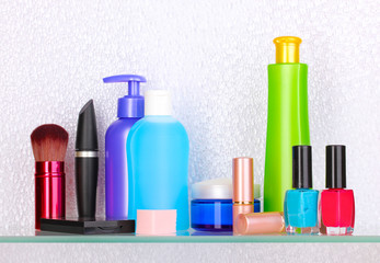 Shelf with cosmetics and toiletries in bathroom