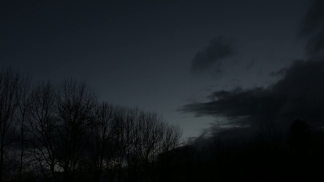Time lapse of clouds moving and sky getting dark.