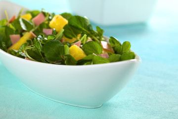 Fresh watercress, pineapple and ham salad in bowl