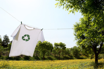T-shirt with recycle logo drying on clothesline