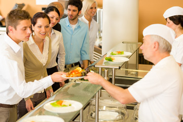 Office colleagues in canteen cook serve meals