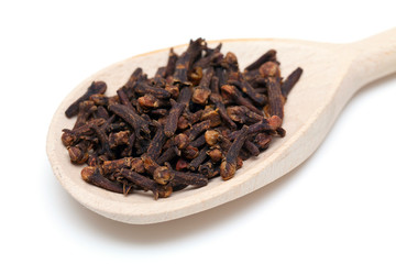 cloves in wooden spoon isolated on white