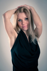 Obraz premium Sad blonde caucasian woman with elegant black dress.