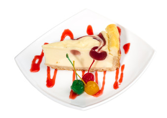 Closeup of a slice of cherry cheesecake on a white background