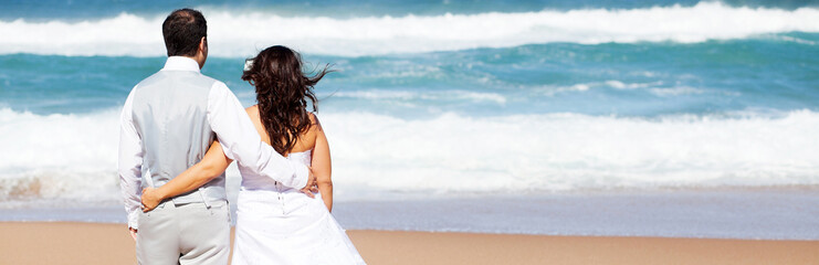 groom and bride on beach