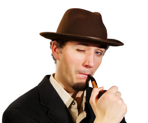 A young man smoking a pipe